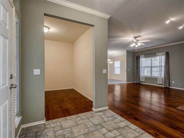 spare room featuring light wood-type flooring, ceiling fan with notable chandelier, and crown molding