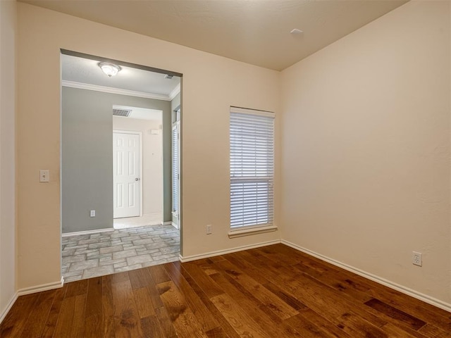 empty room with hardwood / wood-style flooring and crown molding