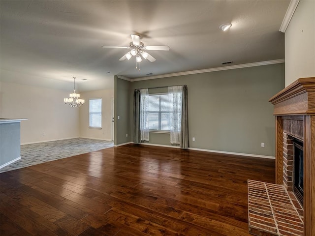 unfurnished living room featuring ornamental molding, ceiling fan with notable chandelier, a brick fireplace, and dark wood-type flooring