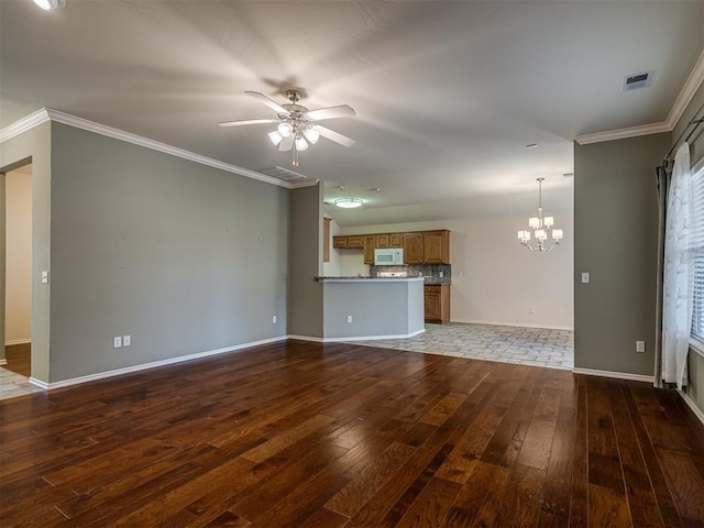 unfurnished living room featuring ceiling fan with notable chandelier, crown molding, and dark wood-type flooring