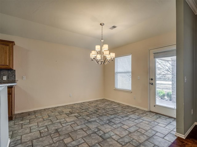 unfurnished dining area with an inviting chandelier