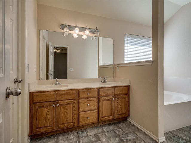 bathroom featuring vanity, a bathtub, vaulted ceiling, and ceiling fan