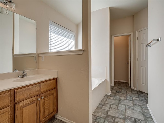 bathroom with vanity and a tub