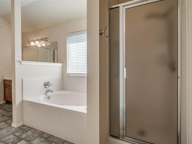 bathroom featuring vanity and independent shower and bath