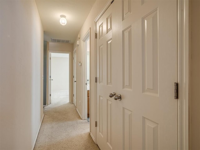 hall featuring light colored carpet