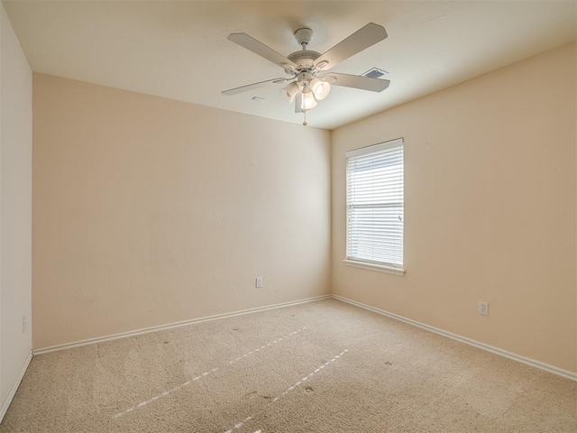 unfurnished room with ceiling fan and carpet floors