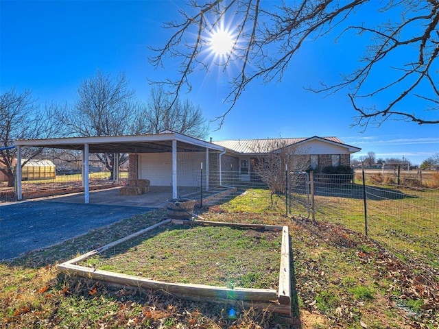 view of front facade with a garage and a carport