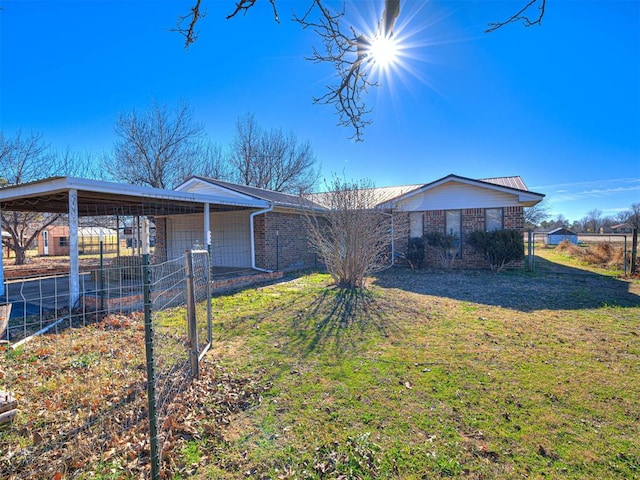 ranch-style home featuring a front yard and a carport