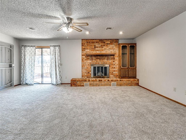 unfurnished living room featuring a fireplace, a textured ceiling, carpet floors, and ceiling fan