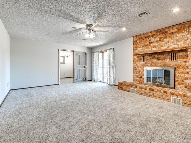 unfurnished living room with light carpet, a textured ceiling, a brick fireplace, and ceiling fan