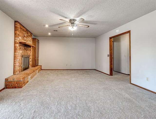 unfurnished living room featuring a fireplace, ceiling fan, light colored carpet, and a textured ceiling