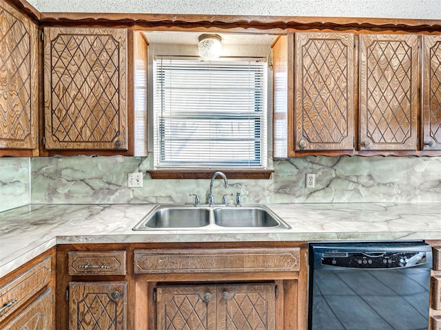 kitchen with dishwasher, decorative backsplash, and sink