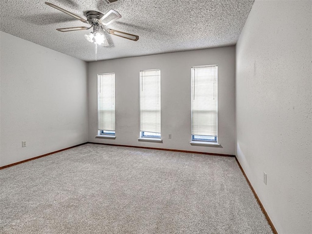 carpeted empty room with a textured ceiling and ceiling fan