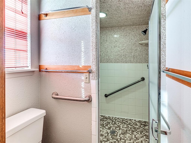 bathroom with toilet and walk in shower