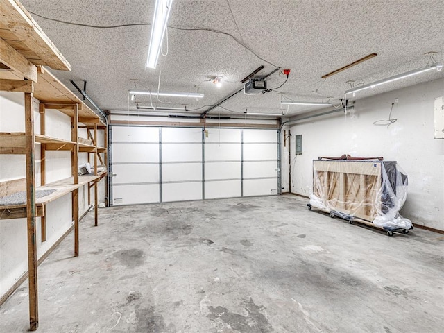 garage featuring electric panel and a garage door opener