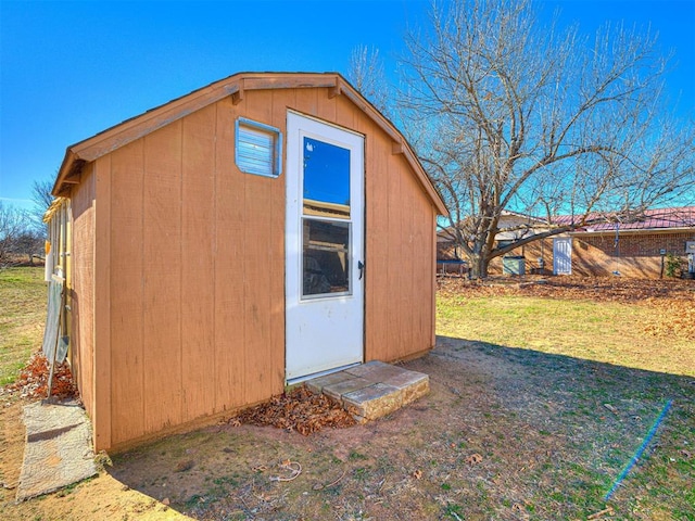 view of outbuilding with a yard