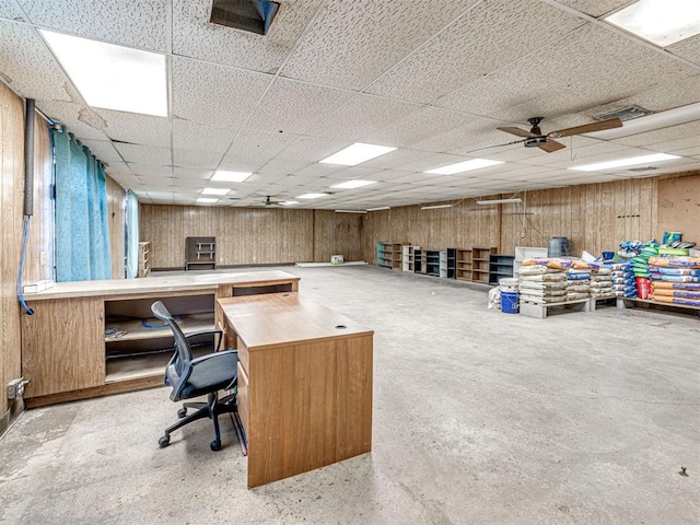 home office featuring ceiling fan and a drop ceiling