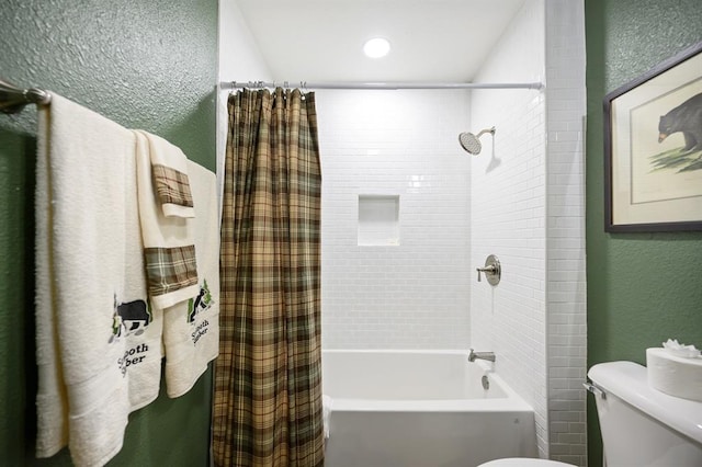 bathroom with shower / bath combination with curtain and toilet