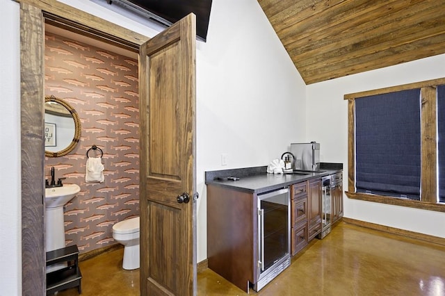 bar with concrete floors, wooden ceiling, wine cooler, and lofted ceiling