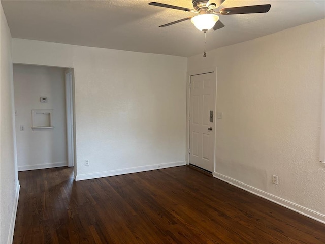 empty room featuring dark hardwood / wood-style floors and ceiling fan