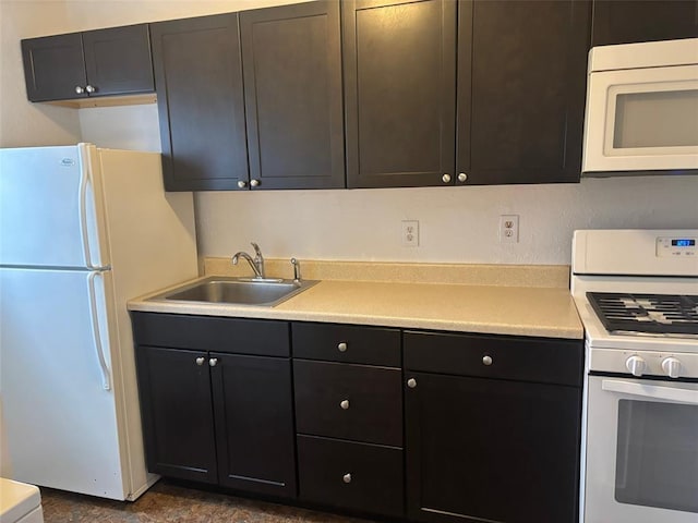 kitchen featuring white appliances and sink