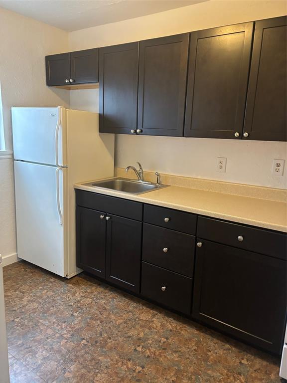 kitchen with white refrigerator and sink