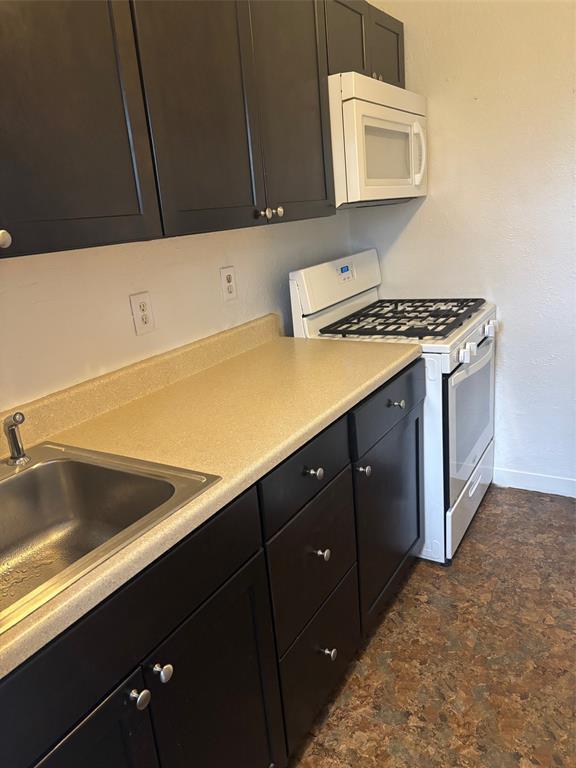 kitchen with white appliances and sink