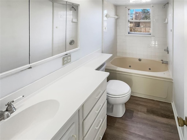 full bathroom featuring wood-type flooring, vanity, toilet, and tiled shower / bath