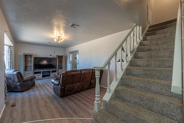 living room featuring a textured ceiling and hardwood / wood-style flooring