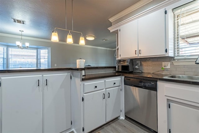 kitchen featuring dishwasher, sink, an inviting chandelier, decorative light fixtures, and white cabinets