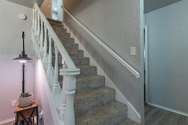 stairway with hardwood / wood-style flooring