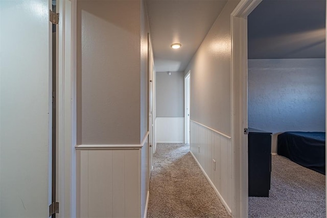 hallway with light colored carpet