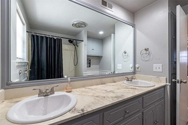 bathroom with a shower with shower curtain and vanity