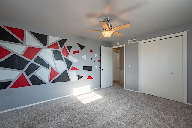 unfurnished bedroom with carpet, ceiling fan, and a closet