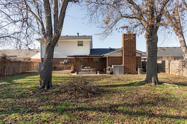 rear view of property featuring a yard, a patio area, and central air condition unit