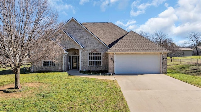 view of front of home with a garage and a front lawn