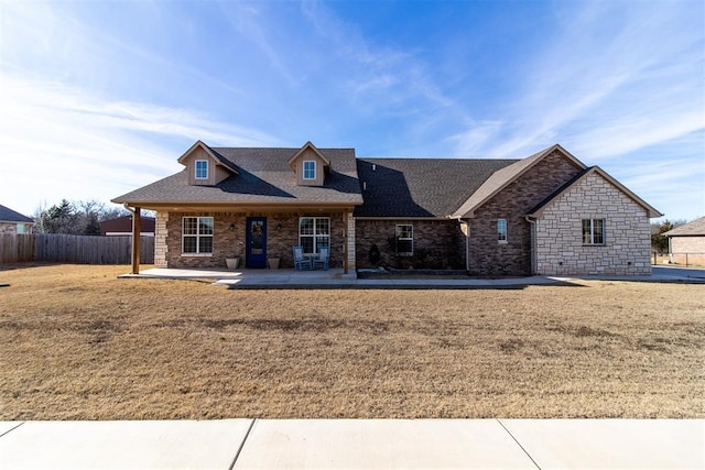 view of front facade featuring a front yard and a patio