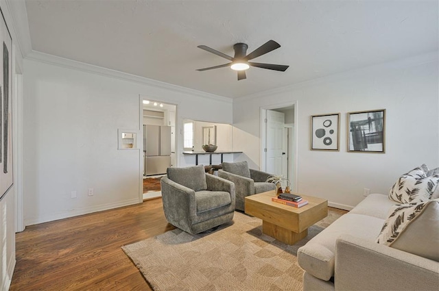 living room with wood-type flooring, ceiling fan, and crown molding