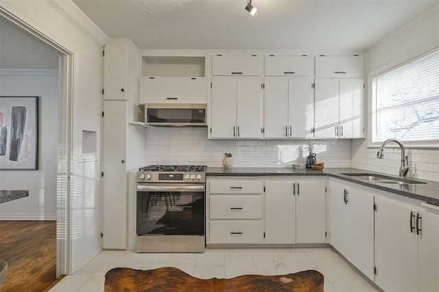 kitchen with sink, white cabinets, and appliances with stainless steel finishes