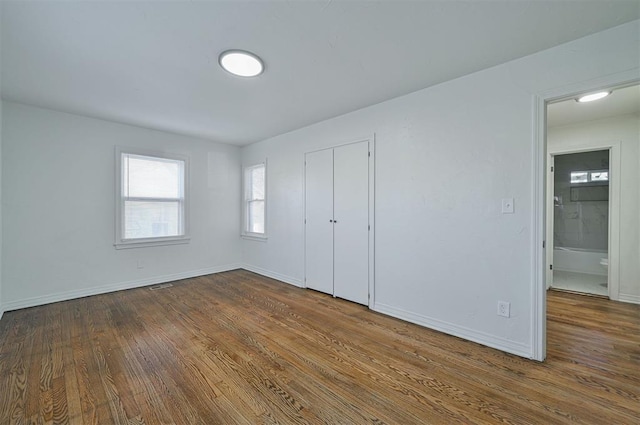 unfurnished bedroom featuring a closet and wood-type flooring