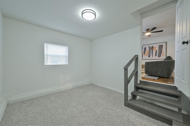 empty room with ceiling fan, crown molding, and carpet floors