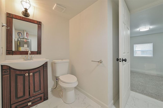 bathroom featuring water heater, vanity, and toilet