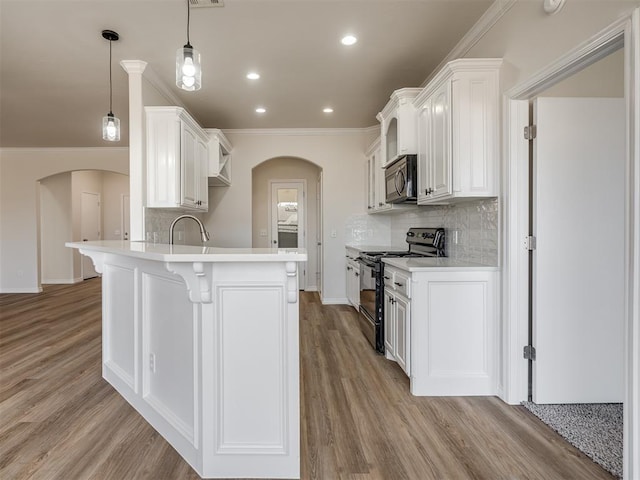 kitchen featuring decorative light fixtures, white cabinetry, black / electric stove, and ornamental molding