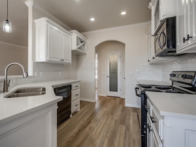 kitchen with sink, decorative light fixtures, white cabinets, black dishwasher, and stainless steel stove
