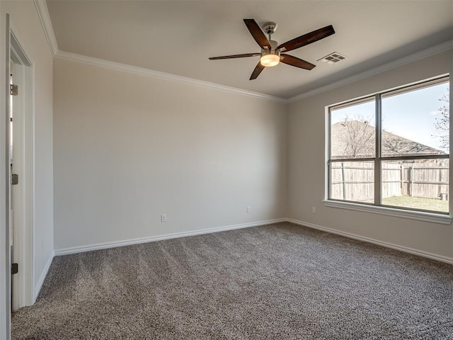 spare room with ceiling fan, carpet floors, and crown molding