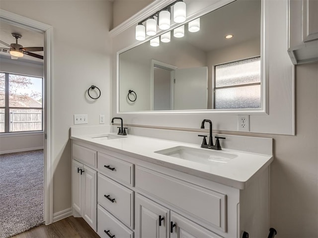 bathroom with ceiling fan, wood-type flooring, and vanity