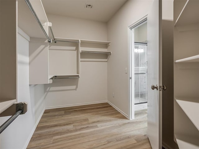 walk in closet featuring light wood-type flooring