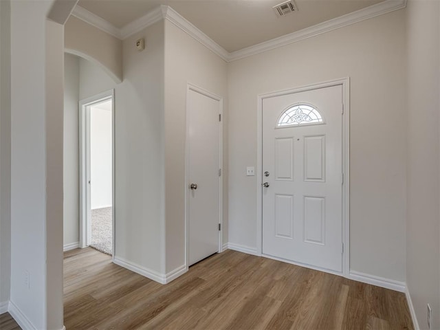 entryway featuring light hardwood / wood-style floors and crown molding
