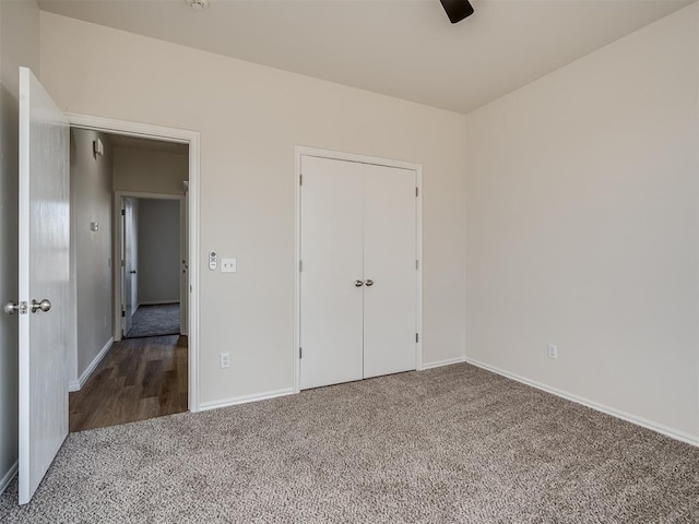 unfurnished bedroom featuring carpet flooring, ceiling fan, and a closet