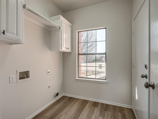 laundry room with washer hookup, light hardwood / wood-style flooring, cabinets, and hookup for an electric dryer